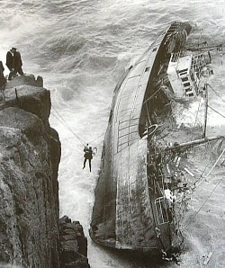 Getting ashore, one at a time, swaying in the wind, hoping the rope doesn't break!